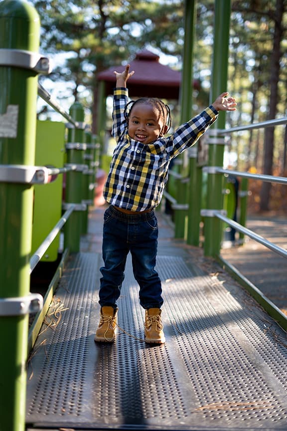 Children Portrait Boy Plaid Shirt Playground Arms Raised - Spring Lake, NC